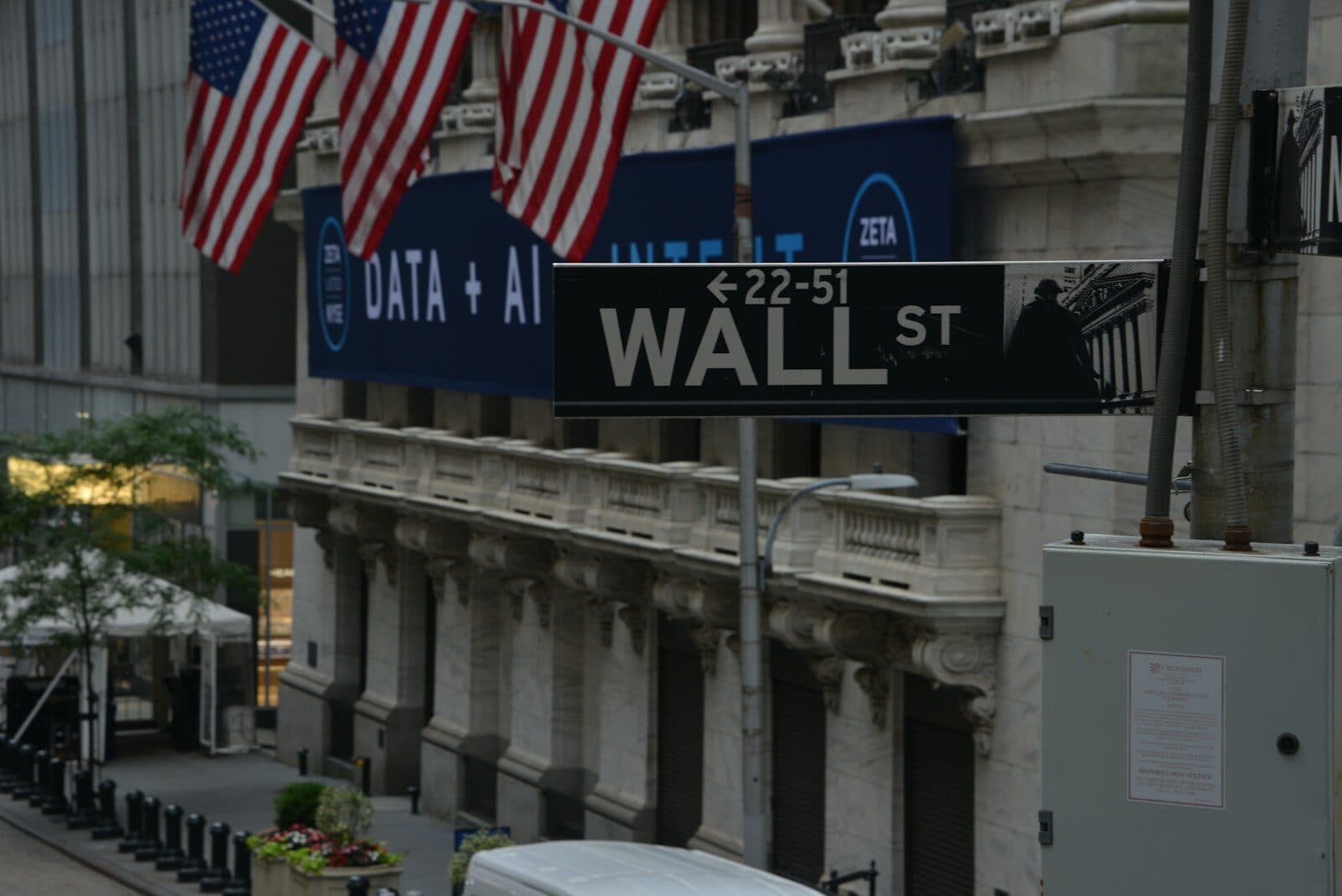 a street sign on wall street in new york city