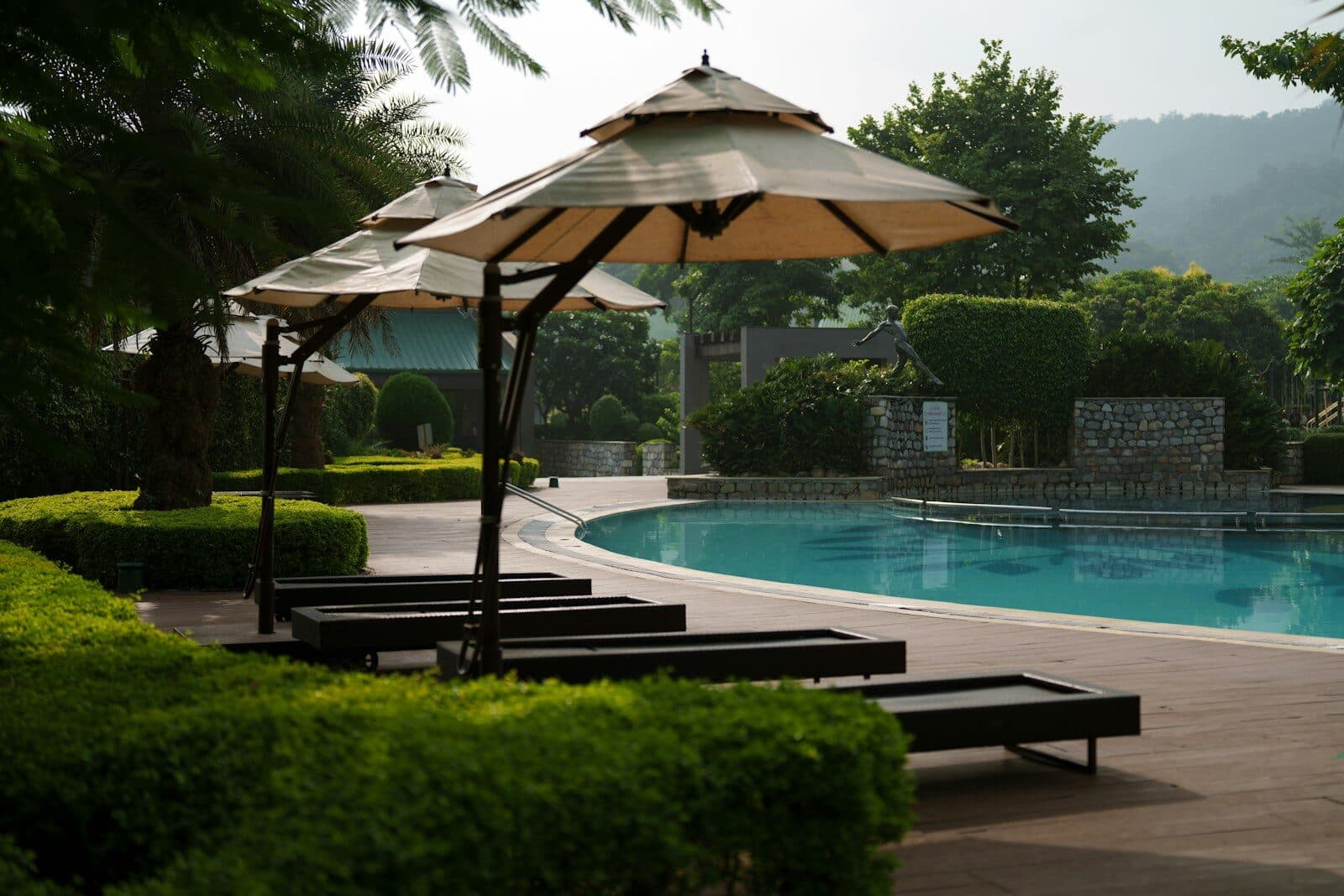 Lounge chairs and umbrellas by a swimming pool