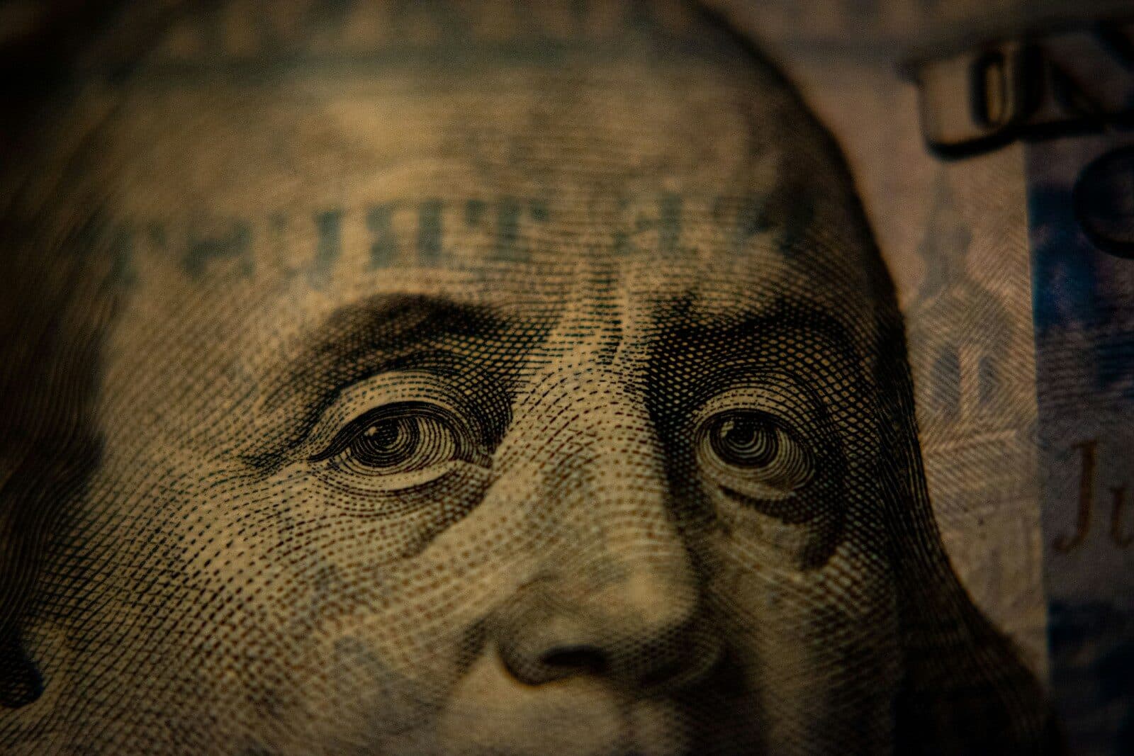 A close-up of Benjamin Franklin on a United States one hundred dollar bill