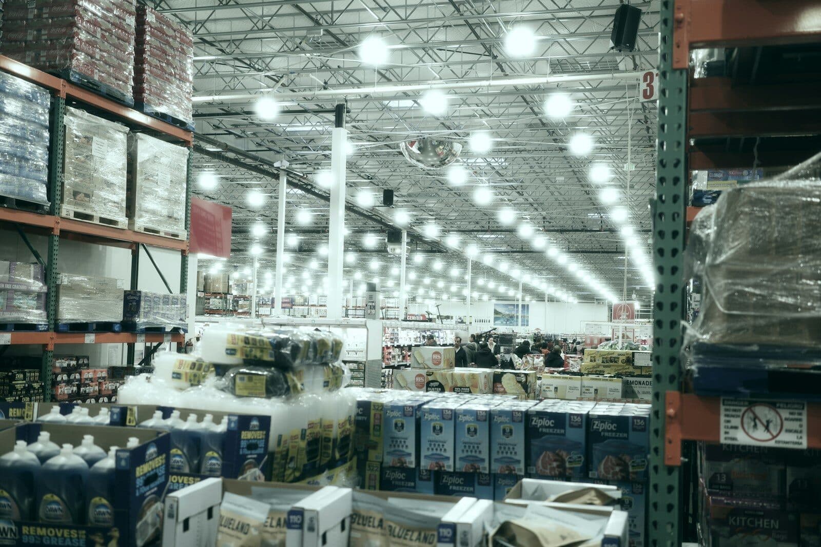 A wide aisle in a brightly lit warehouse store
