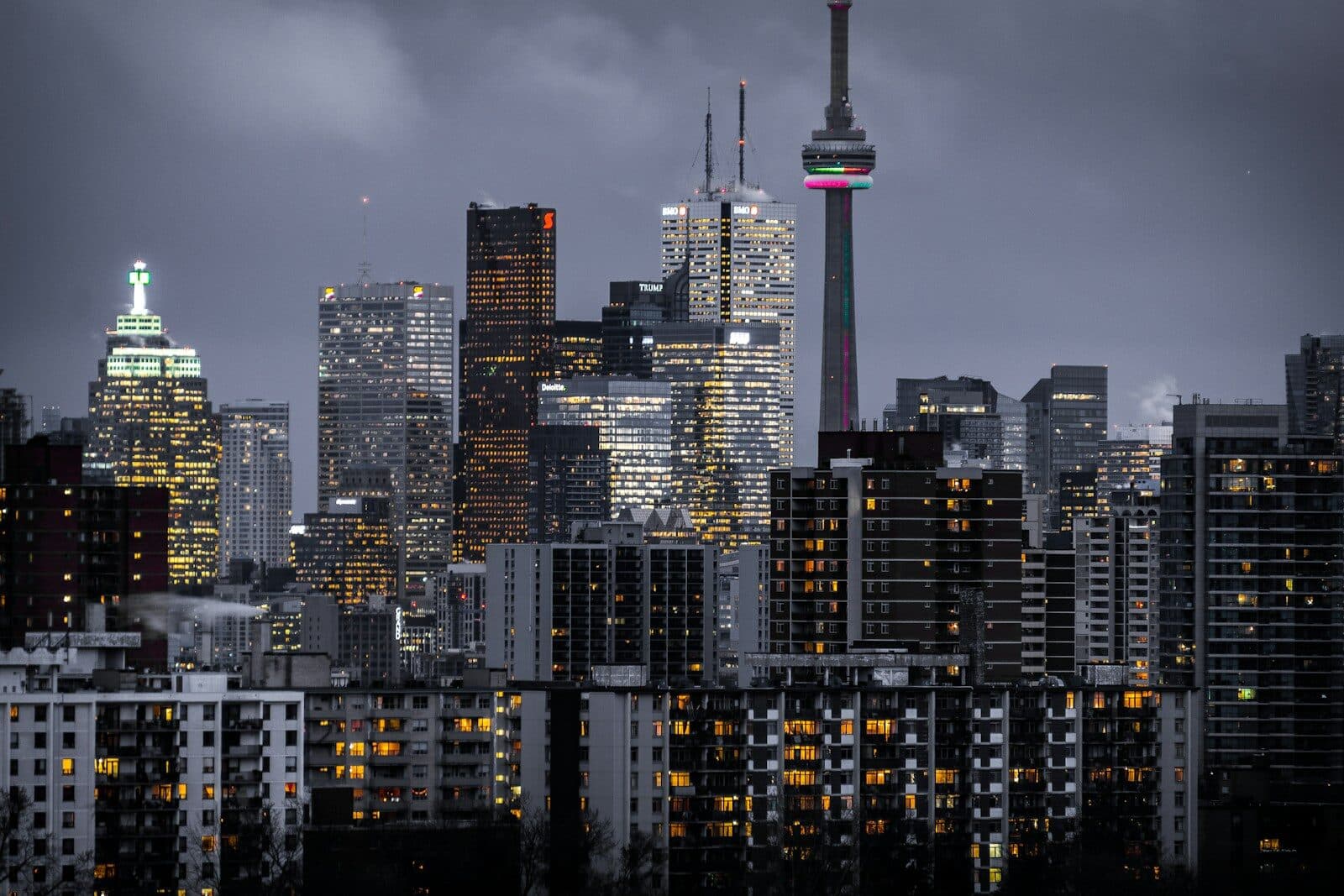 The CN Tower and illuminated skyscrapers in the Toronto skyline at dusk