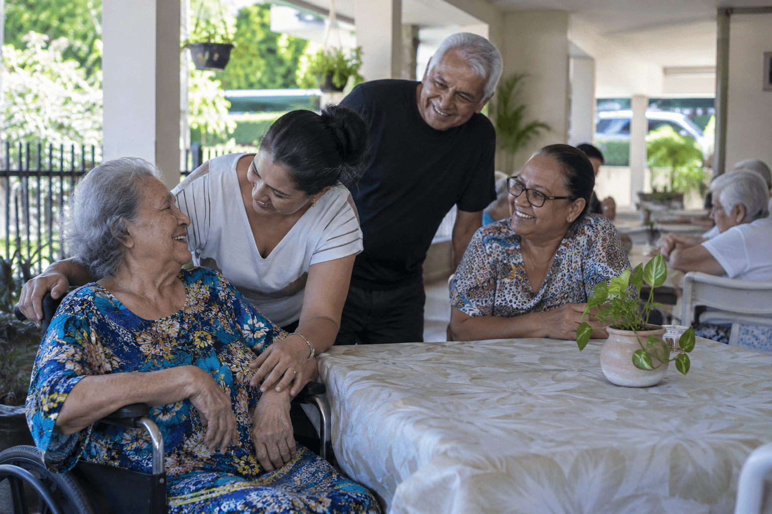 AI-generated editorial image: Elderly folks being with family members visiting them at an elderly home in Puerto Rico.